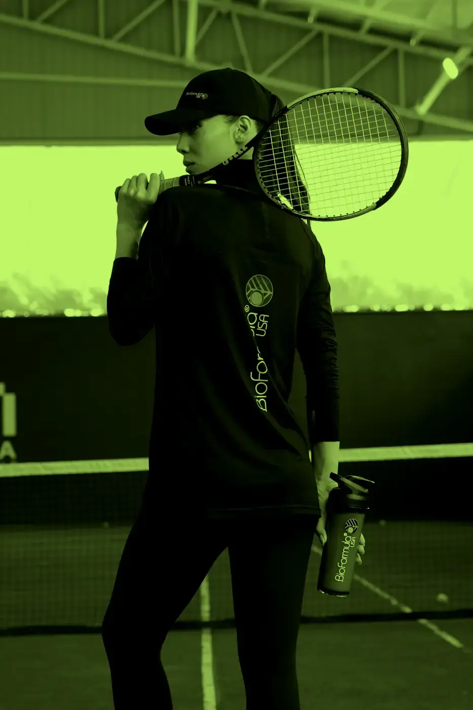 An athlete in BioFormula kit on court, carrying a BioFormula shaker